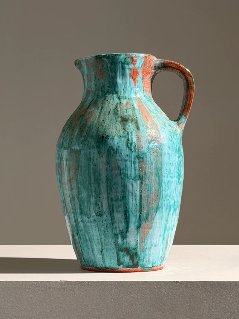 Large pitcher in green glazed earthenware, south of France, circa 1960.